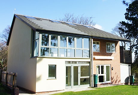 modern house with a curtain wall on the upstairs wall.