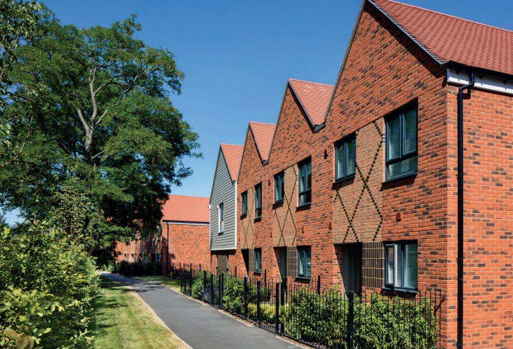 a row of 4 terrace houses with a tree on the left side