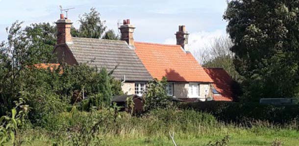 detached houses with grass in the foreground.