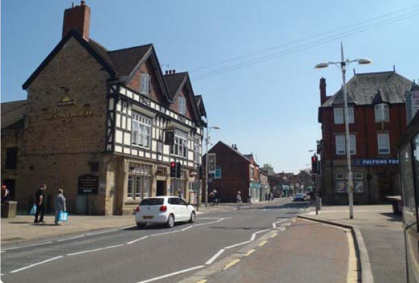 a village street with tudor-style victorian housing.