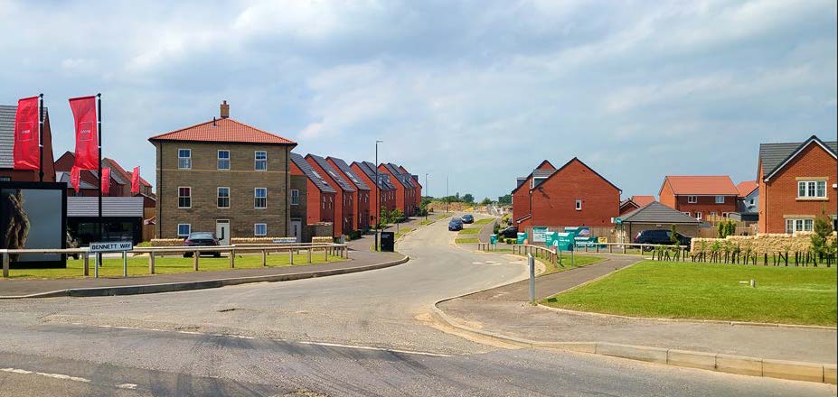 A new build neighbourhood with an open space and green space.