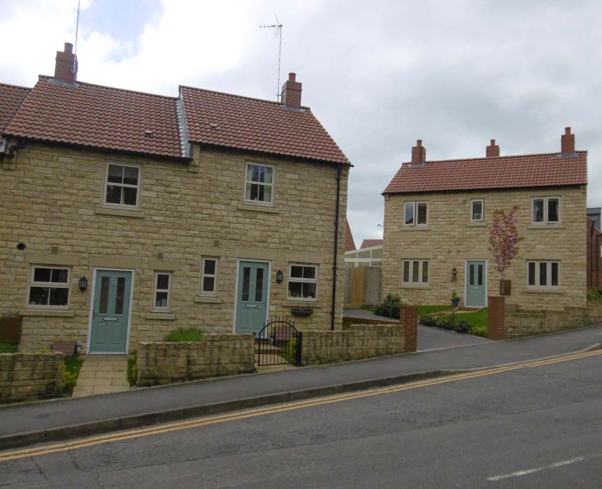 Detached housing along a street.