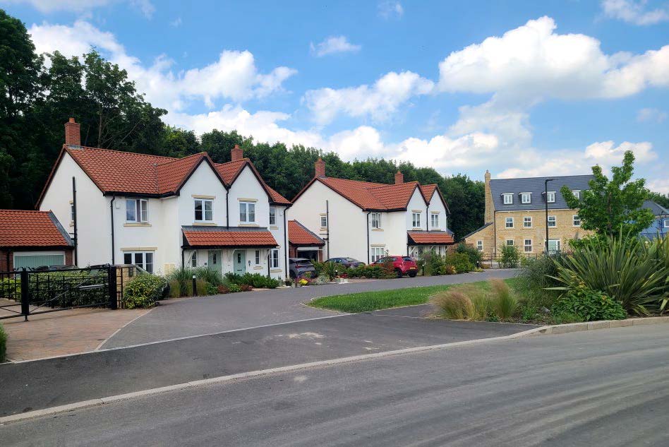 Semi-detached houses with open space along a street.