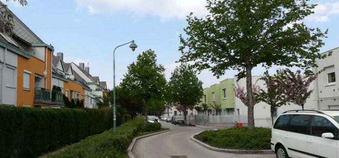 street with houses and small trees and a roundabout