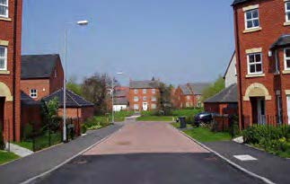 A large neighbourhood of detached houses, open spaces and trees.